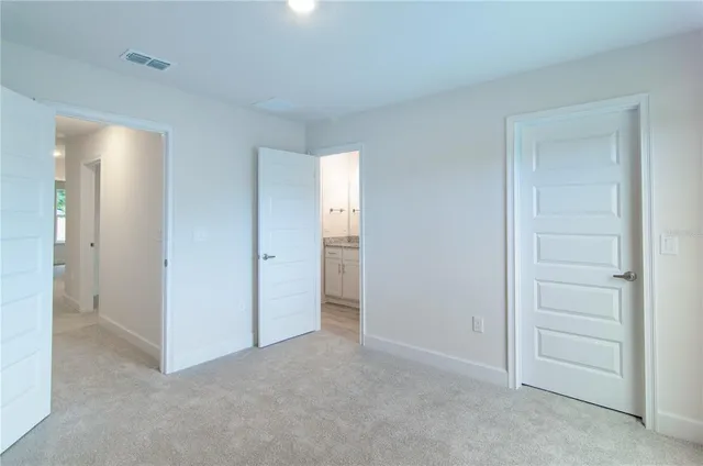 a view of an empty room and closet area