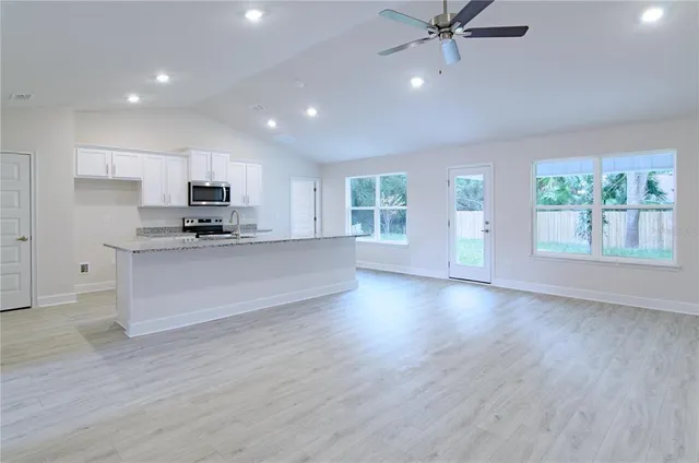 a view of a kitchen with a sink and a window