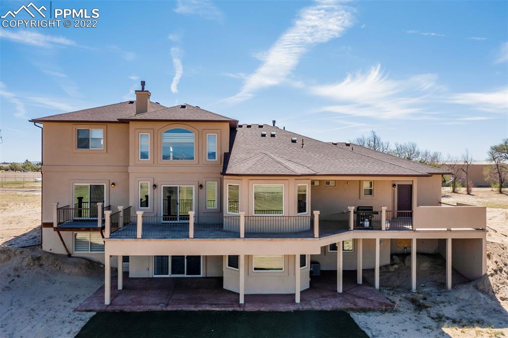 14335 Jones Road Peyton, CO 80831 - Photo 2 of 49 a view of a white building with a table and chairs