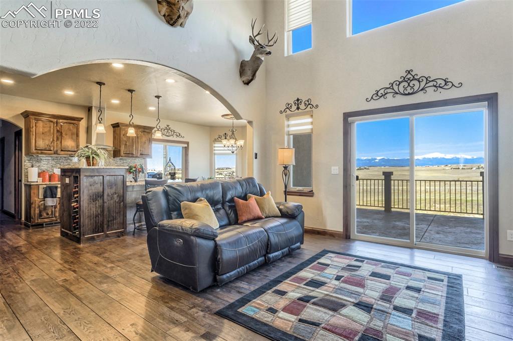 14335 Jones Road Peyton, CO 80831 - Photo 25 of 49 a living room with a couch and a chandelier