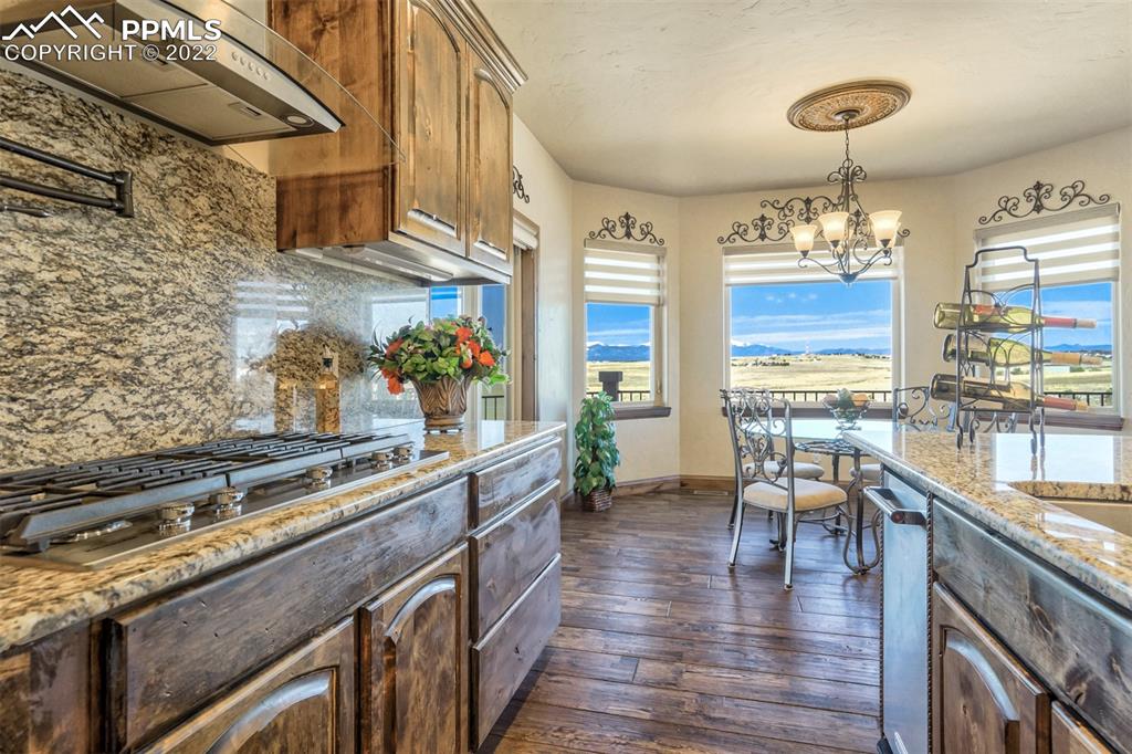 14335 Jones Road Peyton, CO 80831 - Photo 27 of 49 a kitchen with stainless steel appliances granite countertop a stove and cabinets