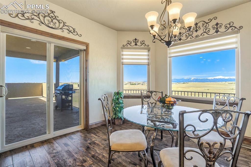 14335 Jones Road Peyton, CO 80831 - Photo 30 of 49 a view of a dining room with furniture wooden floor and chandelier