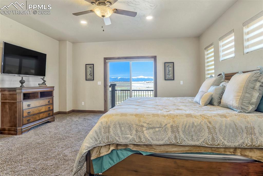 14335 Jones Road Peyton, CO 80831 - Photo 31 of 49 a bedroom with a bed and a flat screen tv