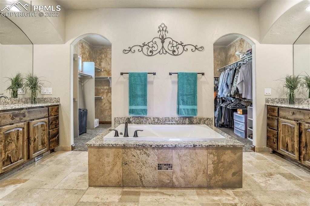 14335 Jones Road Peyton, CO 80831 - Photo 32 of 49 a spacious bathroom with a tub sink and mirror