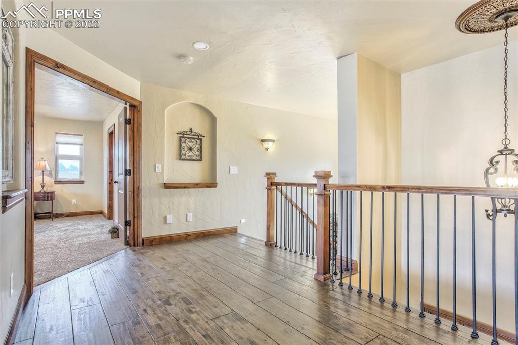 14335 Jones Road Peyton, CO 80831 - Photo 35 of 49 a view of a hallway view with wooden floor and staircase