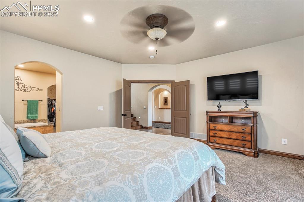 14335 Jones Road Peyton, CO 80831 - Photo 38 of 49 a bedroom with a bed and a flat screen tv