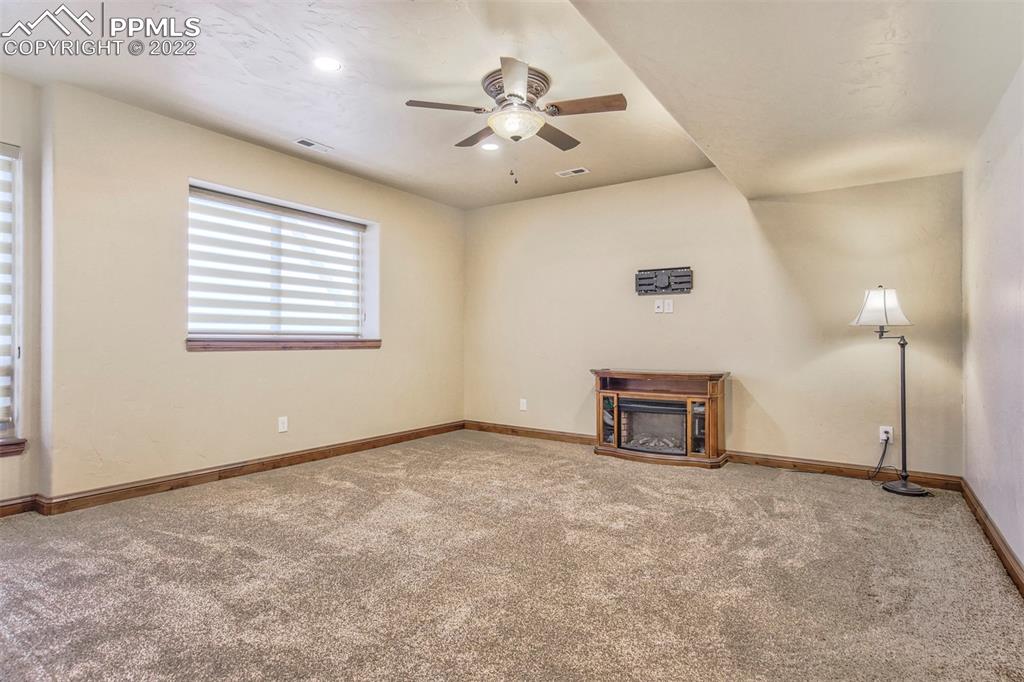 14335 Jones Road Peyton, CO 80831 - Photo 39 of 49 an empty room with windows and a ceiling fan