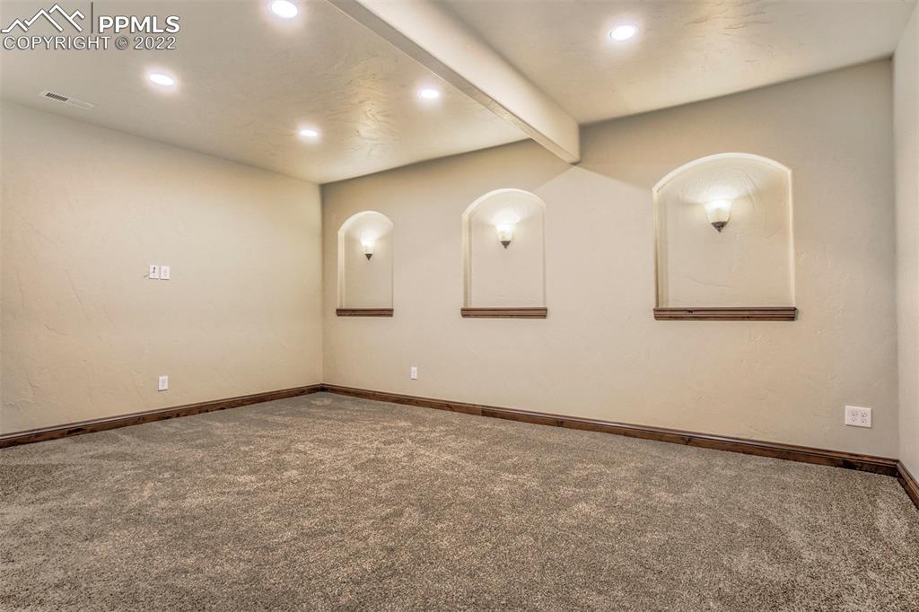 14335 Jones Road Peyton, CO 80831 - Photo 44 of 49 an empty room with wooden floor and mirror