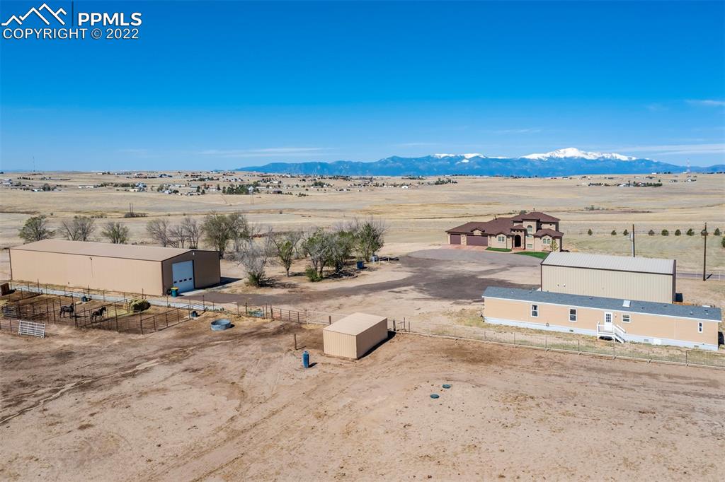 14335 Jones Road Peyton, CO 80831 - Photo 5 of 49 an ocean beach with large trees and buildings in the background