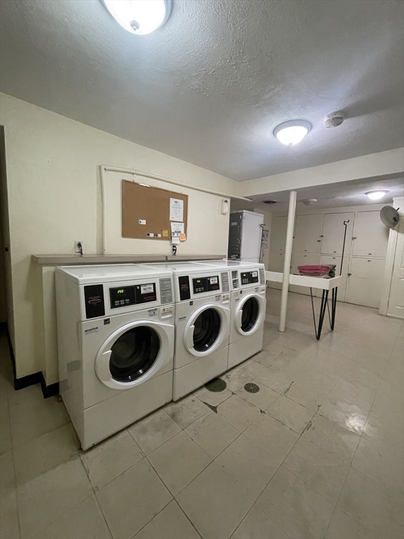 195 Independence Avenue, Unit 118 Quincy, MA 02169 - Photo 15 of 15 a utility room with dryer washer and empty racks