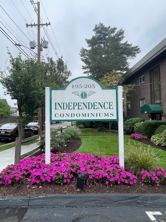 195 Independence Avenue, Unit 118 Quincy, MA 02169 - Photo 2 of 15 a sign board with wooden fence