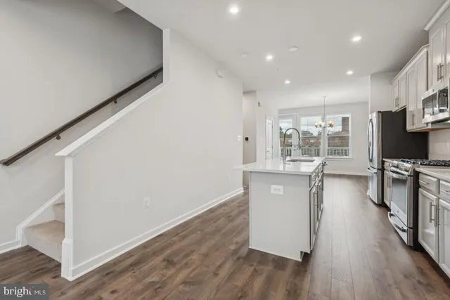 a kitchen with sink and refrigerator