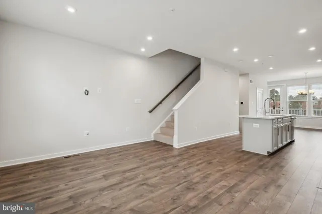 a view of kitchen and hall with wooden floor