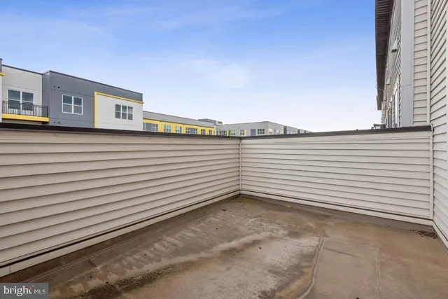 a view of a terrace that has white walls