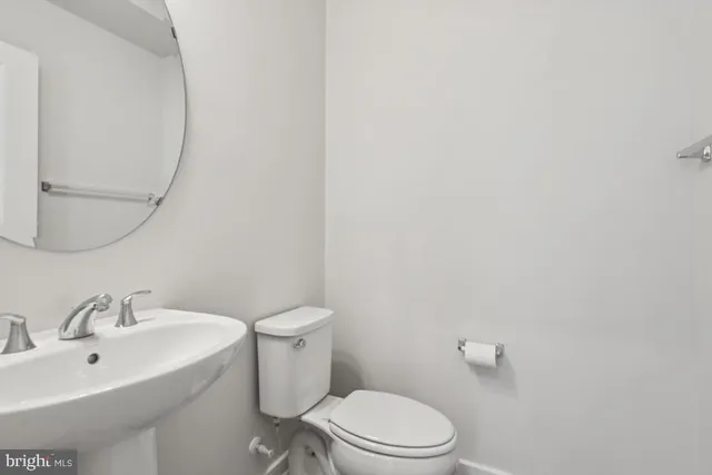 a white toilet sitting next to a bathroom sink