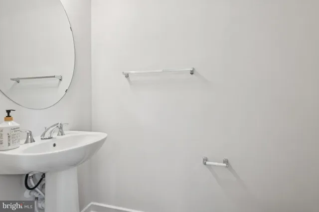 a bathroom with a sink and mirror