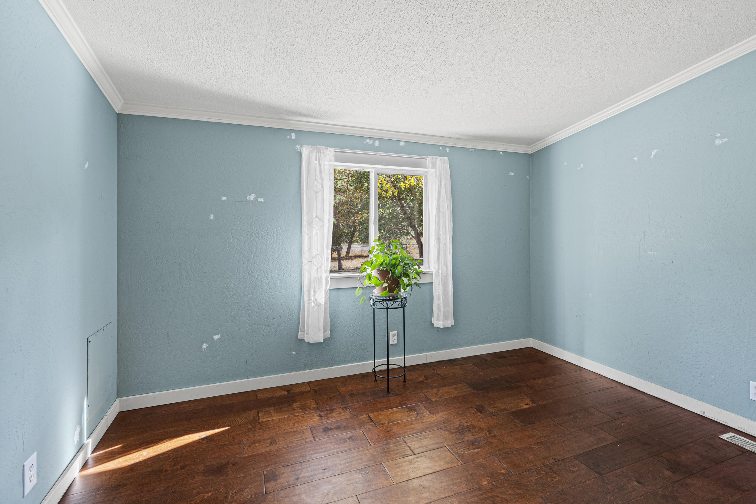14100 Upper Applegate Road Jacksonville, OR 97530 - Photo 13 of 30 a view of a room with wooden floor and a window