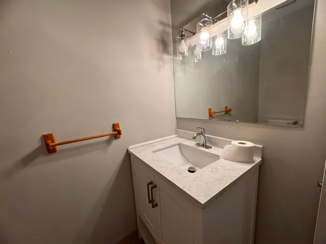 a bathroom with a sink and a mirror