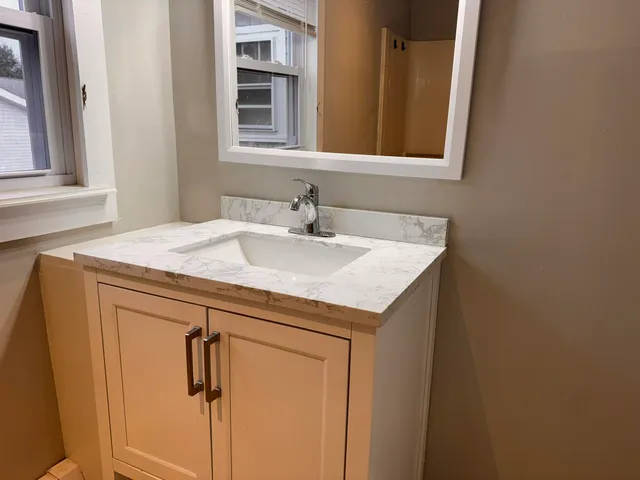 a bathroom with a sink and a mirror