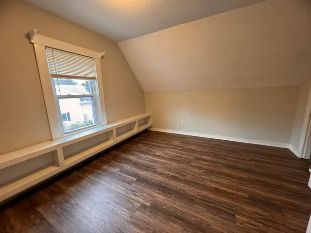 a view of a room with wooden floor and window