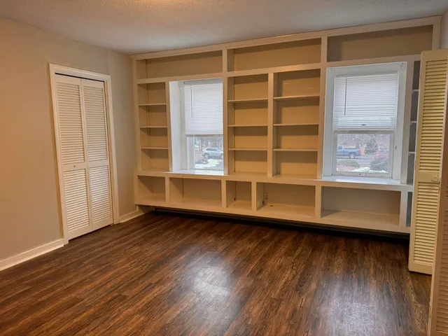 a view of wooden floor and windows in a room