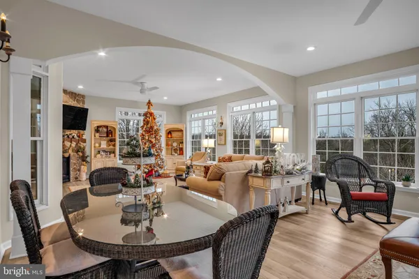 a kitchen with stainless steel appliances kitchen island granite countertop a stove a sink a oven a dining table and chairs