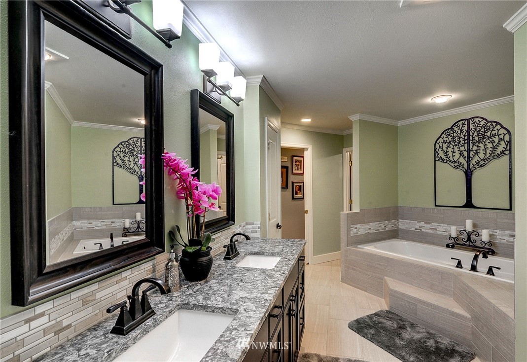 24204 21st Drive Southeast Bothell, WA 98021 - Photo 23 of 39 a bathroom with a granite countertop sink a mirror and a shower