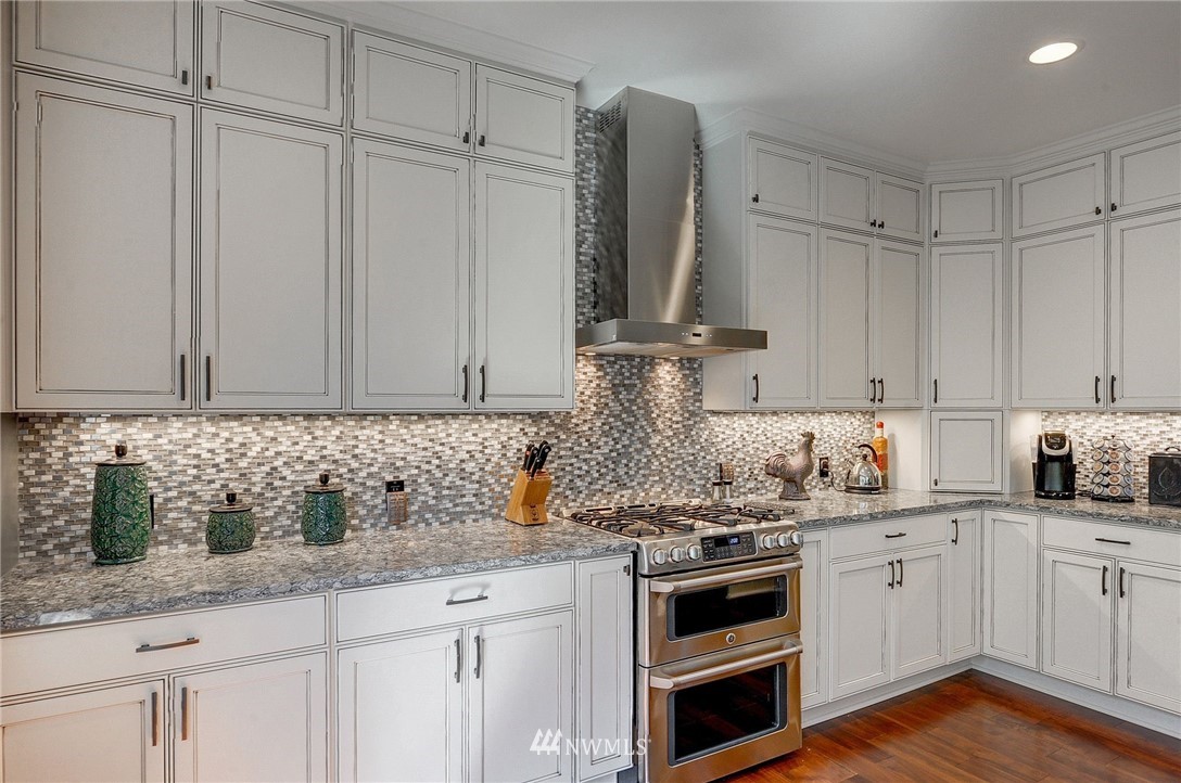 24204 21st Drive Southeast Bothell, WA 98021 - Photo 10 of 39 a kitchen with stainless steel appliances granite countertop a sink a stove and cabinets