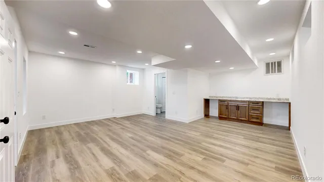a view of empty room with wooden floor