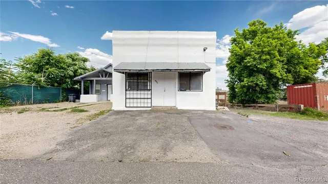 a view of a house with wooden fence