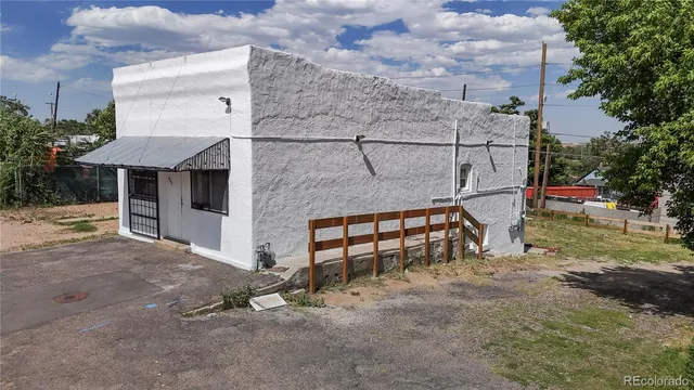 a backyard of a house with table and chairs
