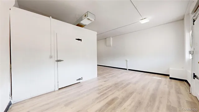 an empty room with wooden floor and closet