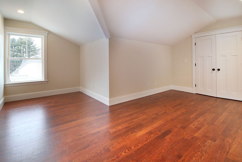 44 Howland Street Needham, MA 02492 - Photo 2 of 18 an empty room with wooden floor and windows