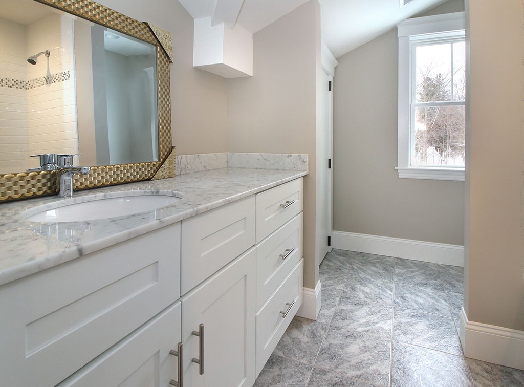 44 Howland Street Needham, MA 02492 - Photo 3 of 18 a bathroom with a granite countertop sink and a mirror