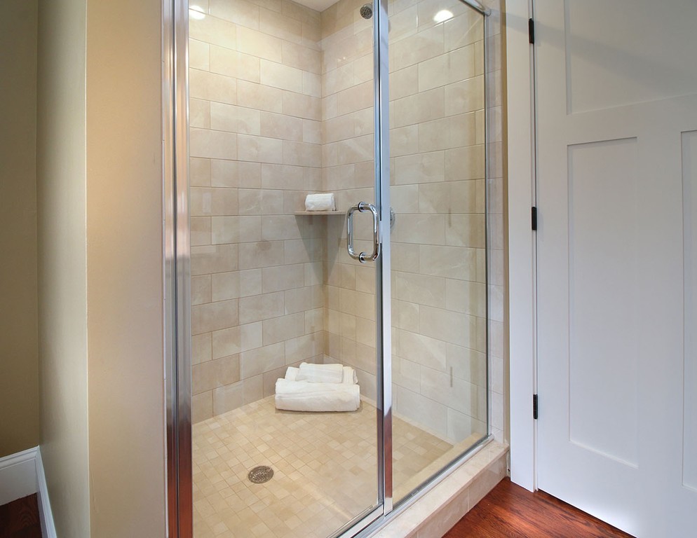 44 Howland Street Needham, MA 02492 - Photo 6 of 18 a bathroom with a glass shower door
