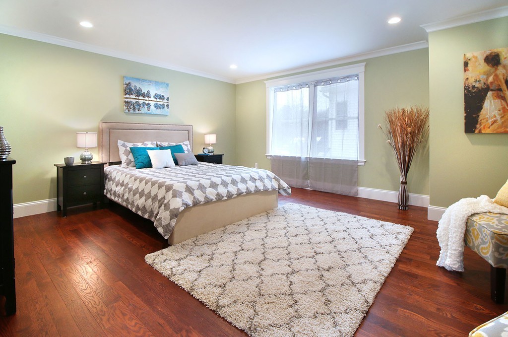 44 Howland Street Needham, MA 02492 - Photo 7 of 18 a bedroom with a bed and wooden floor