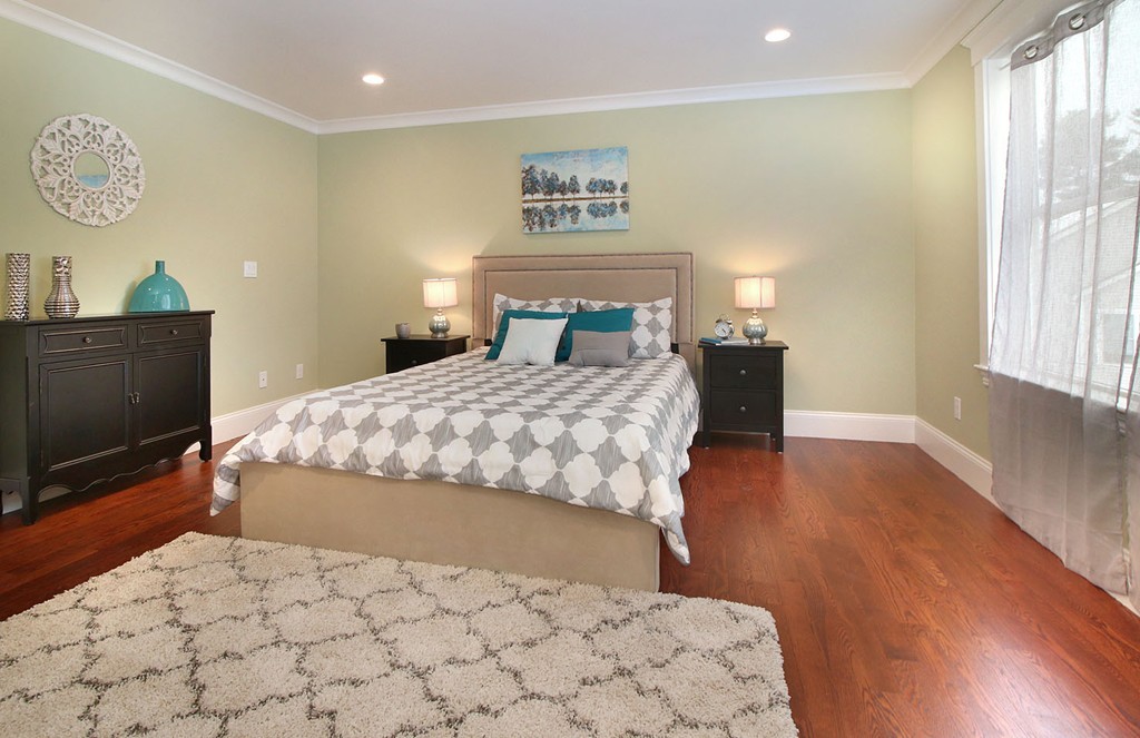 44 Howland Street Needham, MA 02492 - Photo 8 of 18 a bedroom with a bed and a flat screen tv