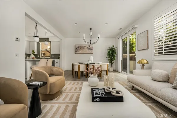 a living room with furniture a dining table and kitchen view