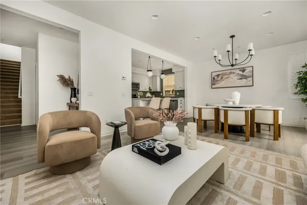 a living room with furniture a window and a chandelier
