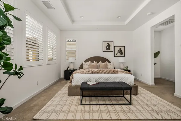 a bedroom with a bed and a painting on the wall