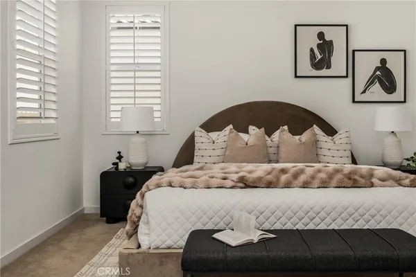 a bedroom with a bed and a potted plant