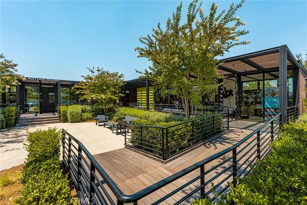 a view of house with yard and sitting area