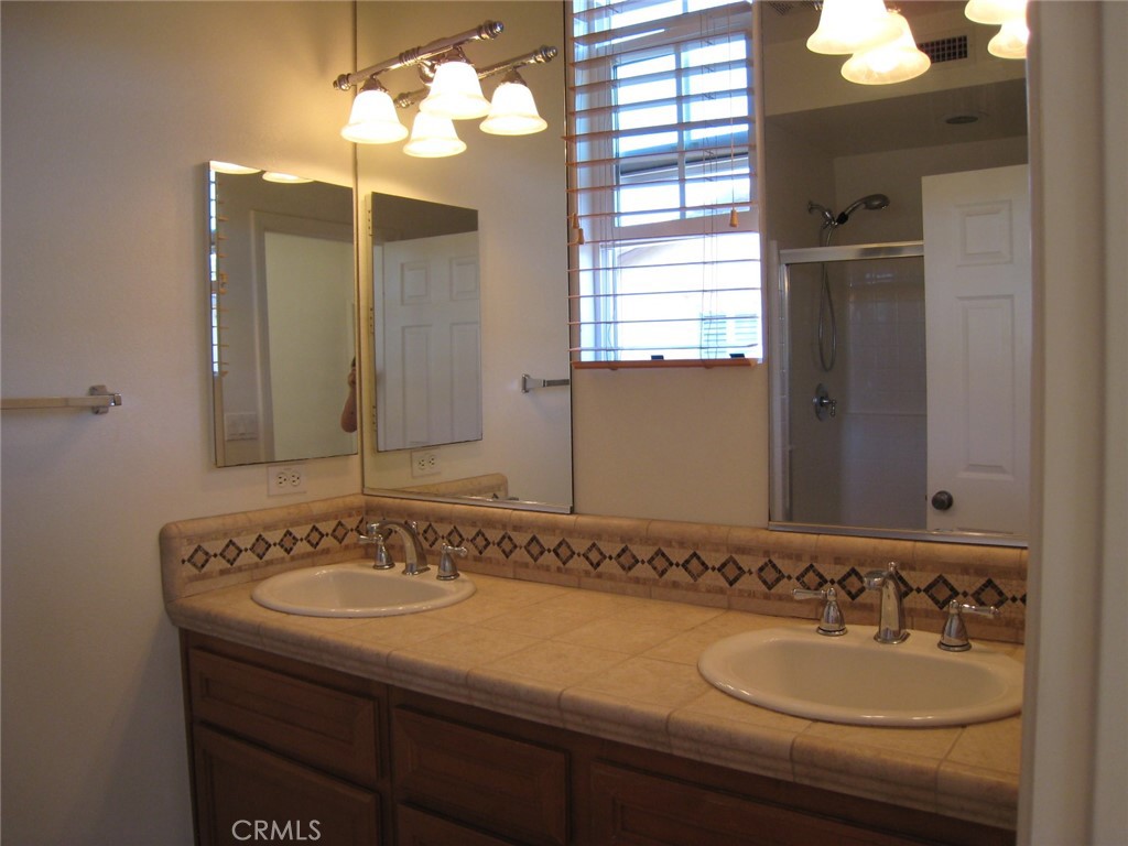 216 Dewdrop Irvine, CA 92603 - Photo 11 of 14 a bathroom with a sink and a mirror