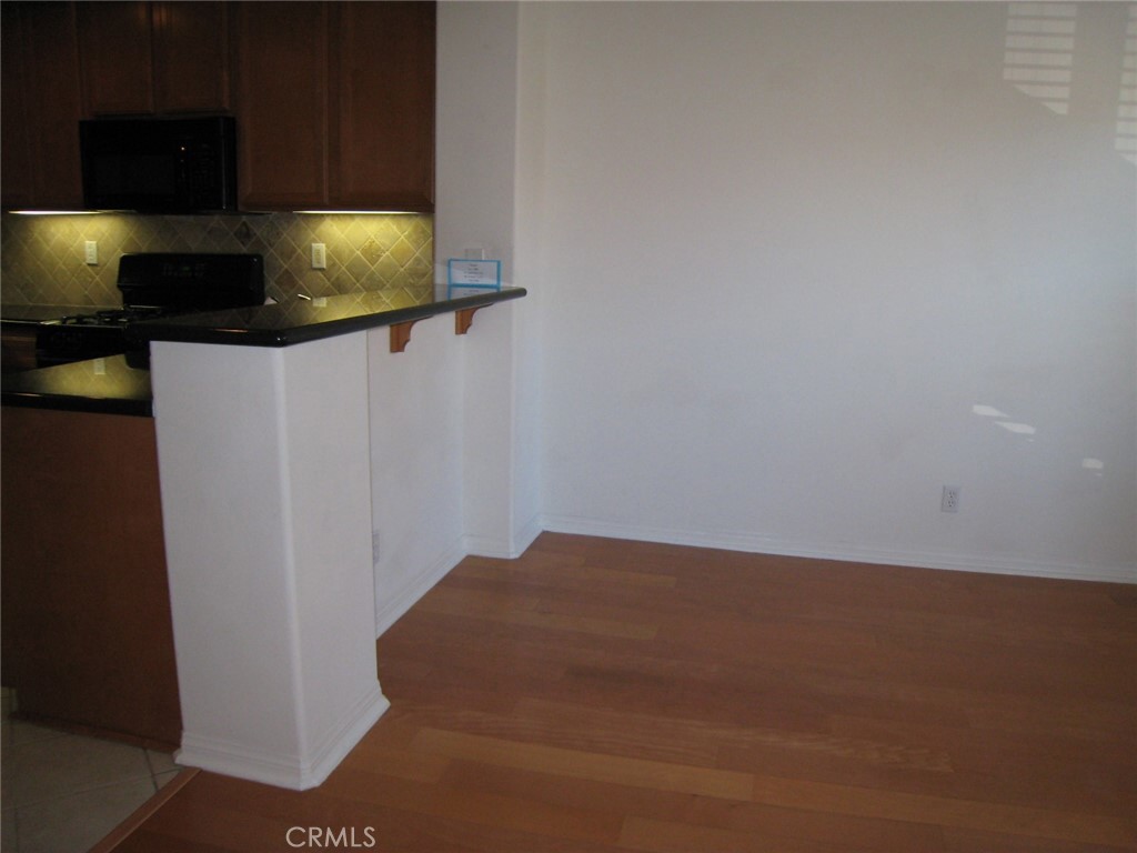 216 Dewdrop Irvine, CA 92603 - Photo 4 of 14 a kitchen with a sink and a microwave
