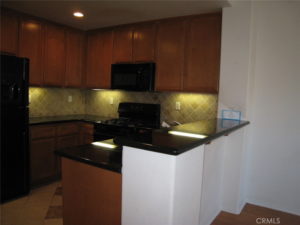 216 Dewdrop Irvine, CA 92603 - Photo 5 of 14 a kitchen with a sink and cabinets