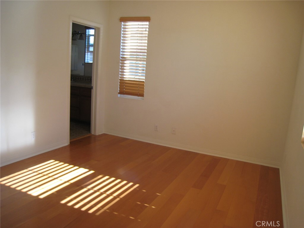 216 Dewdrop Irvine, CA 92603 - Photo 9 of 14 a view of an empty room with wooden floor and a window