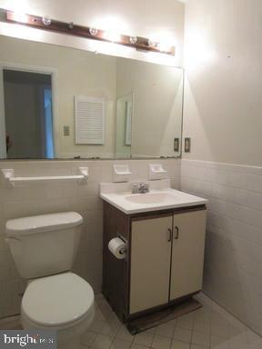1921 Wilson Lane, Unit 303 McLean, VA 22102 - Photo 11 of 12 a bathroom with a toilet sink and mirror