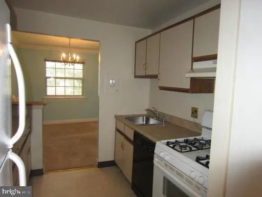 a kitchen with granite countertop a stove and a sink