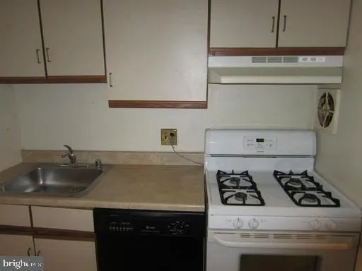 a kitchen with a stove and a sink