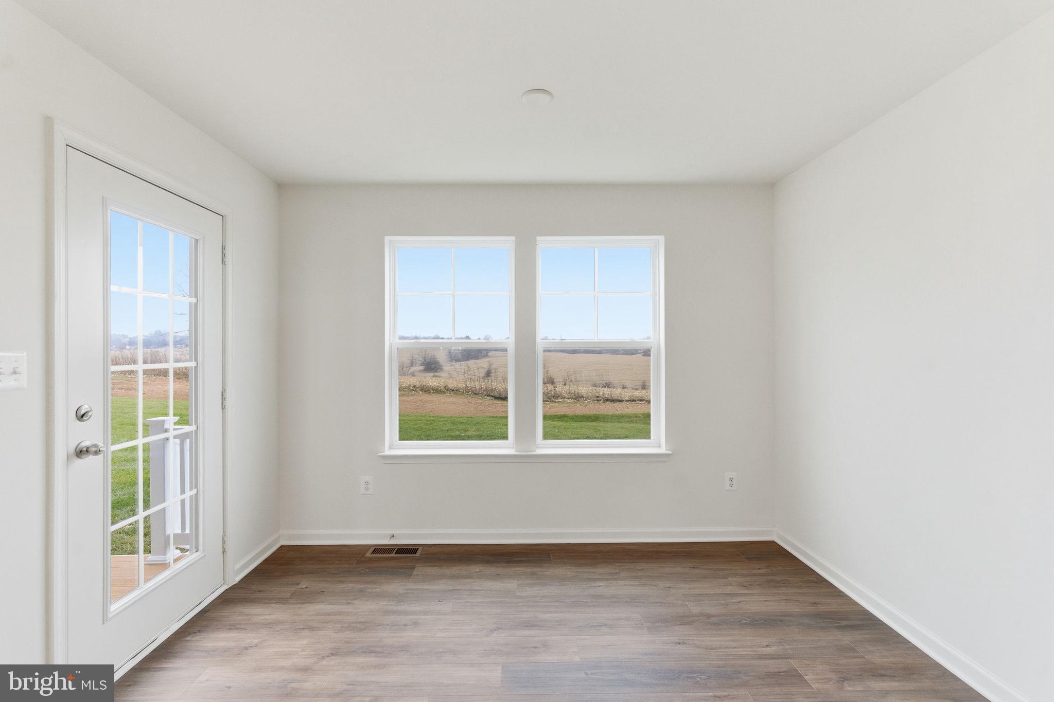 161 Homestead Drive Hanover, PA 17331 - Photo 14 of 43 an empty room with wooden floor and windows
